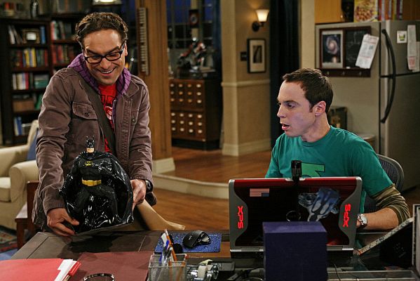 Leonard giving Sheldon a Batman cookie jar.