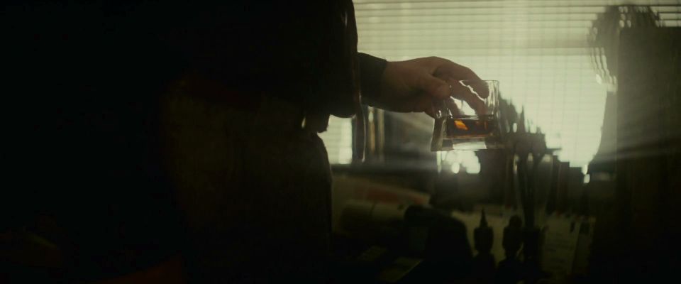 Rick Deckard drinking whiskey in his apartment